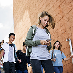 Group of school friends walking down staircase