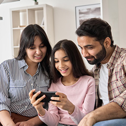 happy-parents-looking-at-teen-photos