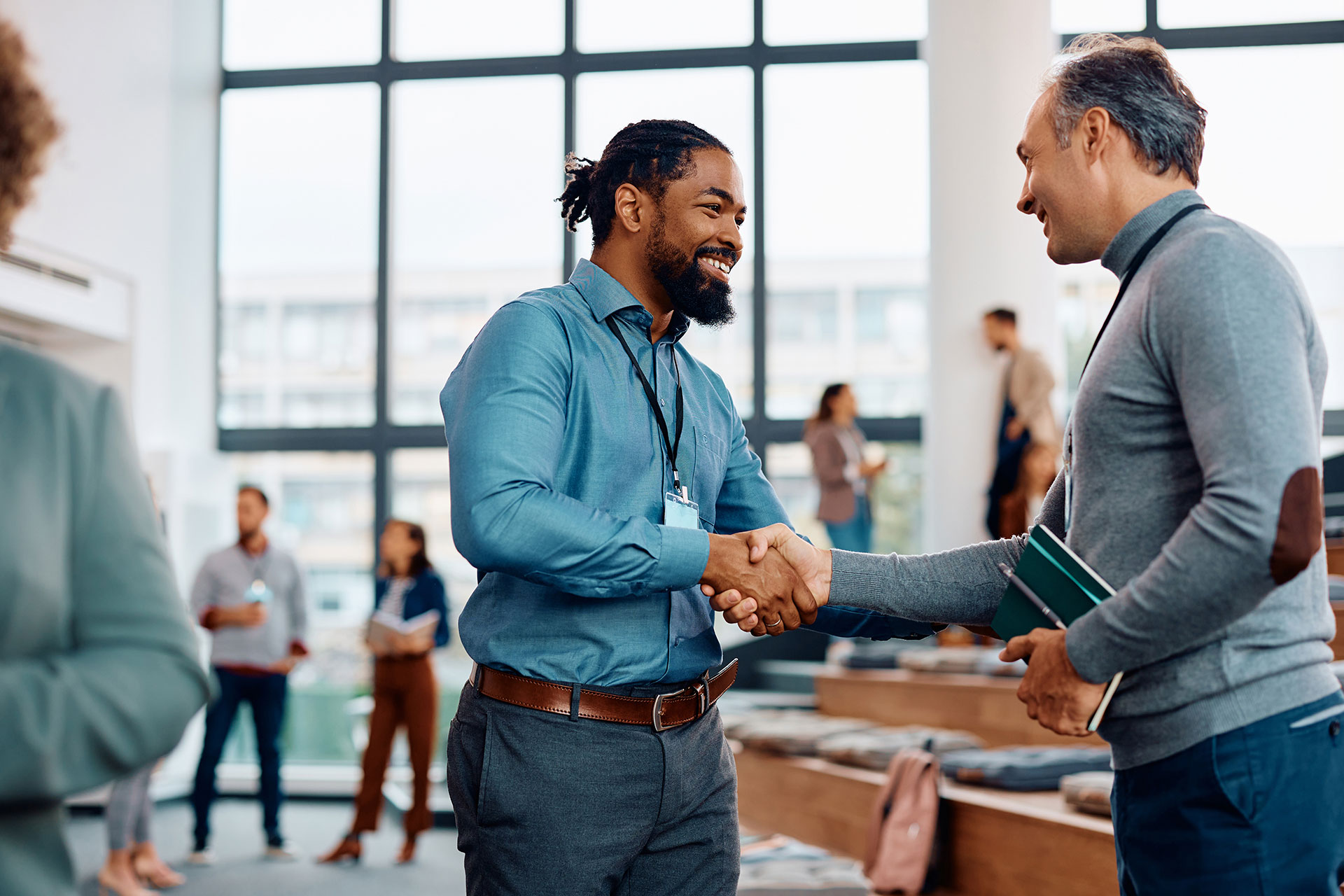 happy-businessmen-greeting-while-attending-an-education-seminar
