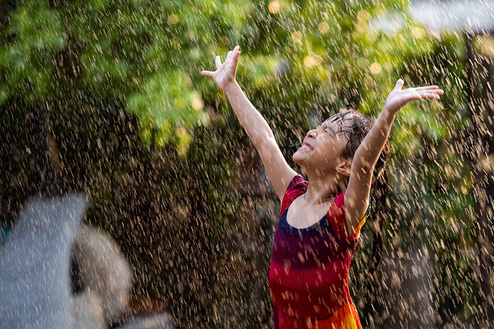 young_girl_happy_raining_getty-images-unsplash_plus